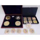 Sixteen gold-plated commemorative medallions with their certificates: a wooden cased set of four (70