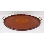 An Edwardian period oval mahogany serving tray; in Georgian style and centrally decorated with a