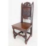 A 19th century carved oak hall chair; solid seat and baluster turned and block front legs united