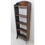 An early 20th century oak open bookcase of slim proportions (foot requires attention) (40.5 cm