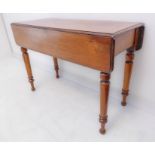 A 19th century mahogany Pembroke table: the short block flaps flanking a single flush drawer, raised