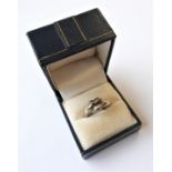 A silver dress ring modelled as two dolphins, ring size N (boxed)
