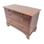 An early 20th century chest of small proportions; moulded top above a brushing slide and two full-