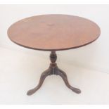 A late 18th to early 19th century circular mahogany tilt-topoccasional table: turned stem; tripod