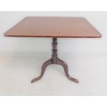 An early 19th century mahogany tilt-top occasional table; turned stem and on a tripod base with