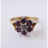A lady's 9-carat yellow gold dress ring (marked '375'): flowerhead cluster with six cut stones (