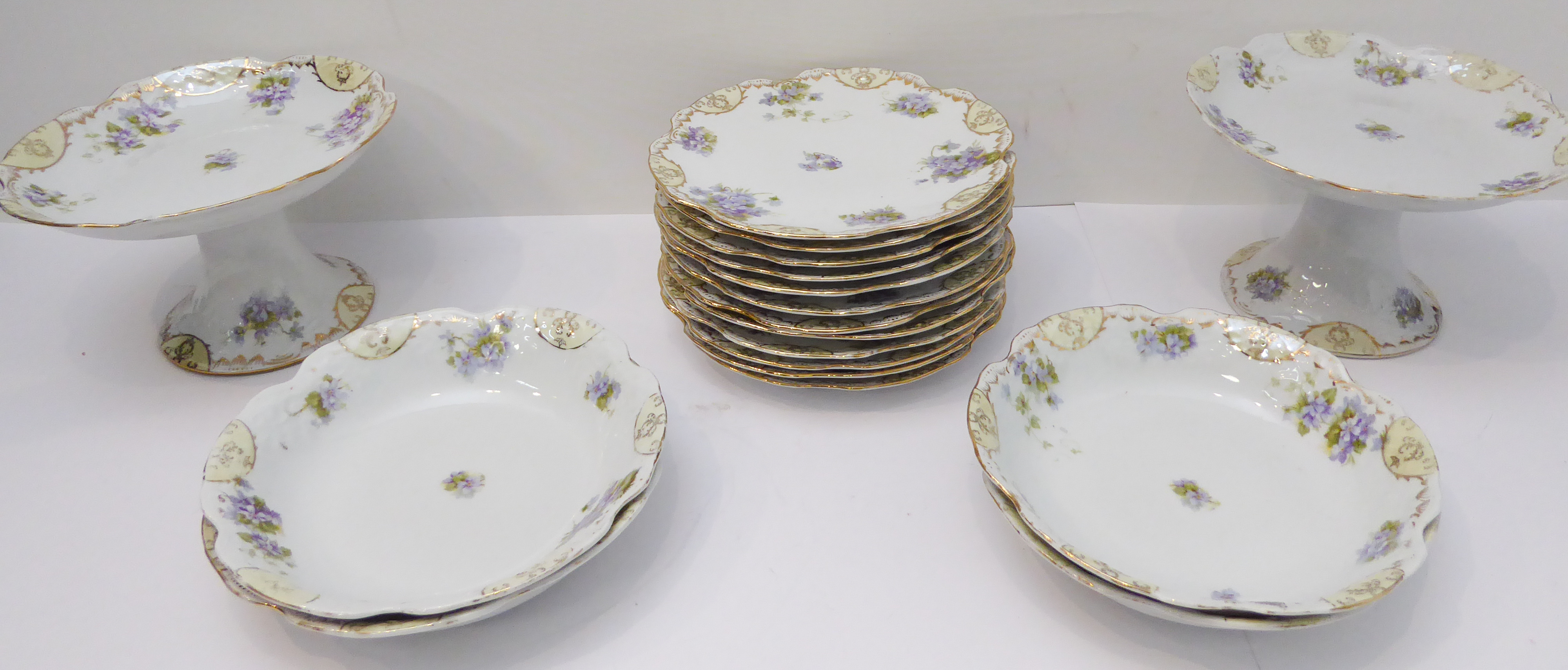 An early 20th century continental dessert service comprising: 12 x 21.5 cm plates, 4 bowls and two