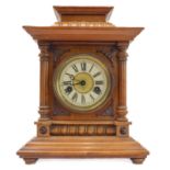 A late 19th century German eight-day mantle clock: the cream chapter ring with Roman numerals; the