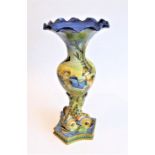 An Italian majolica vase (rim fritting): typically hand-decorated with winged cherubs and raised