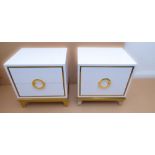 A  pair of Craigsville two-drawer, white lacquer and gilded bedside cabinets, each with semi-