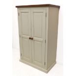A modern stained-wood topped painted two-drawer cupboard: the doors with fielded panels enclosing