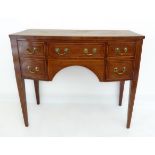 A George III period bow-fronted sideboard of small proportions: mahogany, rosewood crossbanded and