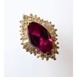 A lady's silver-gilt (marked 925) dress ring: central elliptical vertical pink stone surrounded by