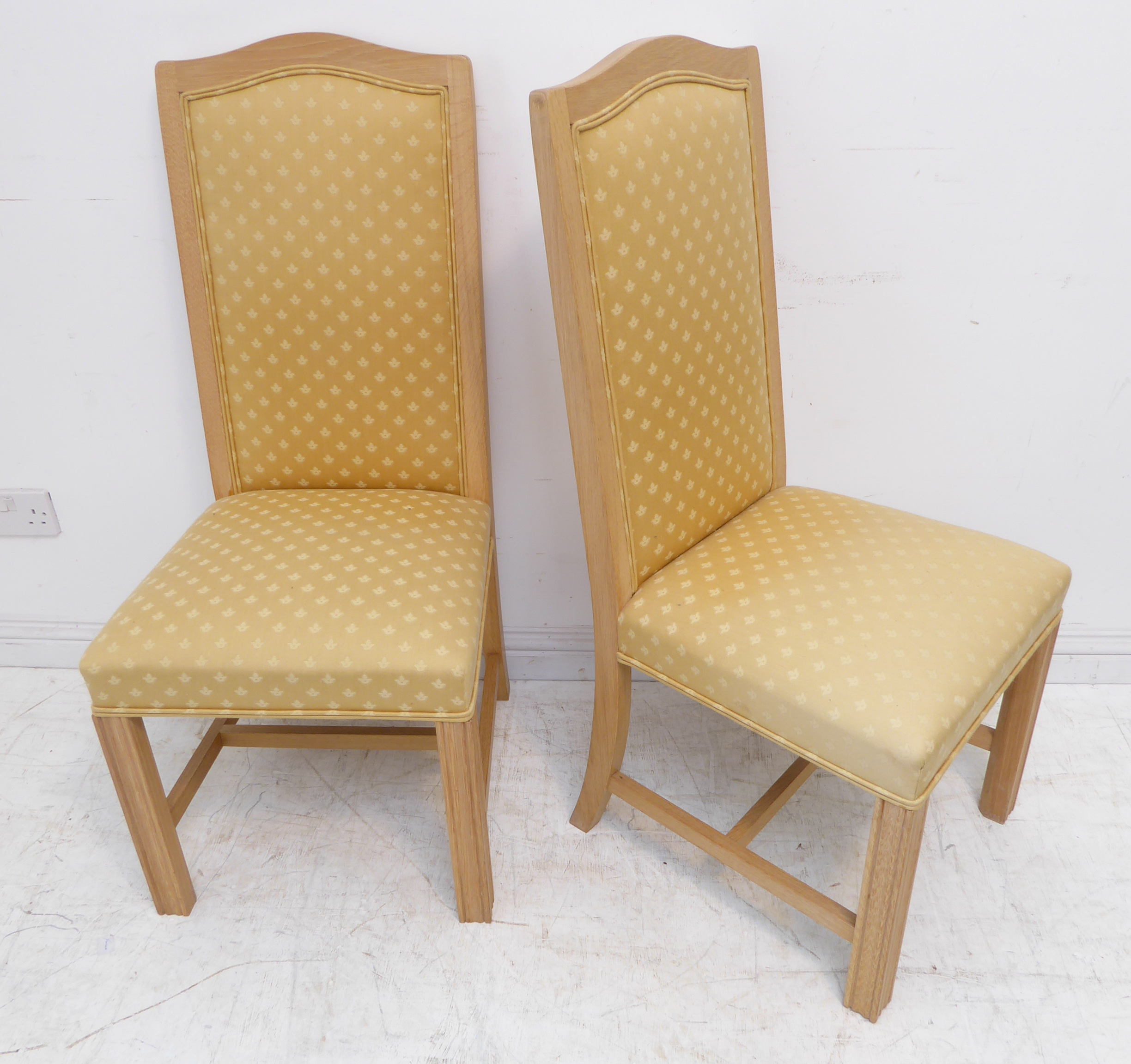 A pair of modern light oak and gold upholstered side chairs with square fluted front legs
