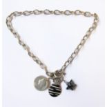 A heavy silver neck chain set with pendants including a 19th century silver coin