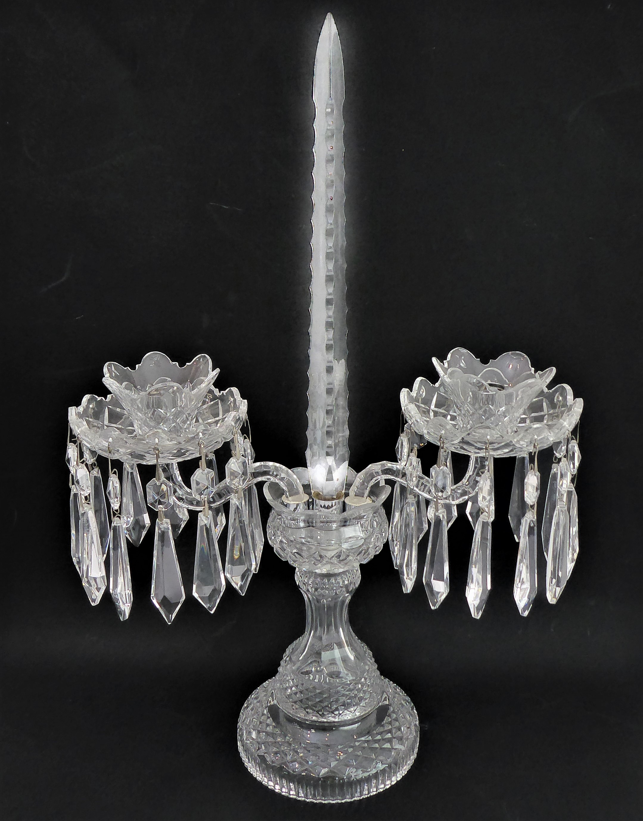 A fine quality cut-glass two-light candelabra table lustre: hand-cut faceted droplets (marked