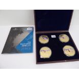 A set of four gold-plated 'Britain's Darkest Hour' medallions in their wooden case and a boxset of