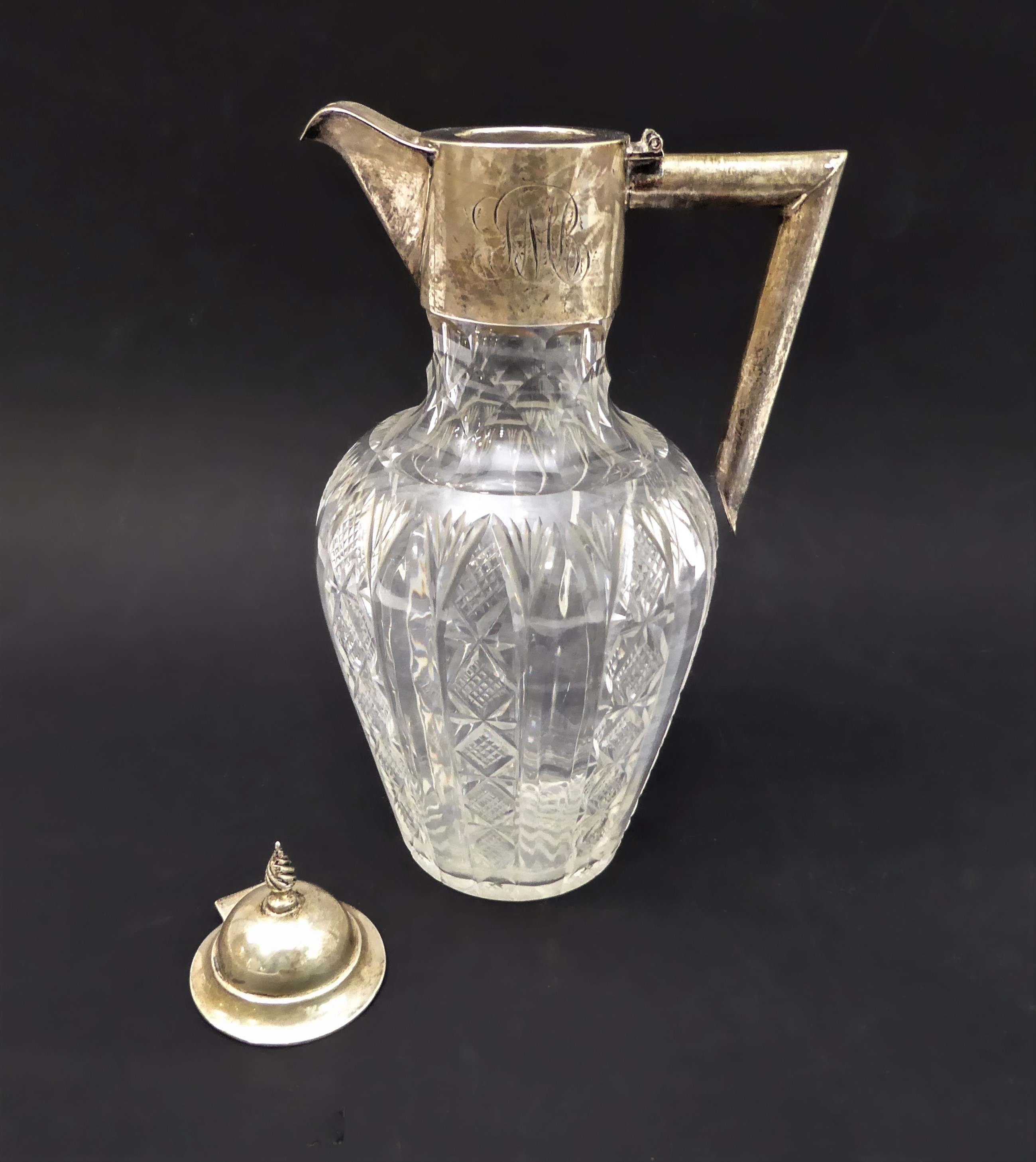 An early 20th century silver-mounted cut-glass claret jug, assayed Chester 1901 (hinged cover now