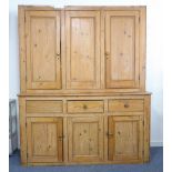 A very large 19th century pine dresser; the top section with three panelled doors above three