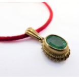A 9-carat gold and emerald pendant