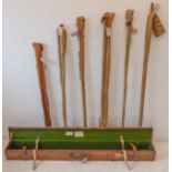 An Ogden Smiths canvas and leather fishing rod case (151 x 15 x 15 cm) and 6 spit-cane rods: Hardy