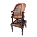 A late Regency or early Victorian child's mahogany and rattan caned bergère-style highchair on stand