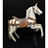 A finely carved and painted wooden model of a rearing white horse supported by a metal front