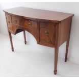 An early 20th century bow-fronted mahogany sideboard in late 18th century George III style: