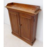 A late Regency to mid-19th century mahogany side-cabinet of small and slim proportions: the