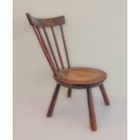 A 19th century circular-seated Welsh-style spinning-stool: on four turned splaying legs, of good