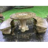 A stoneware circular garden table with two matching concave benches by Stamcombe Stone, Stroud.