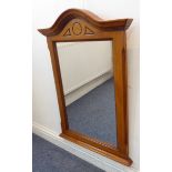 A modern cherrywood wall-hanging looking glass having serpentine-style top and moulded side