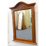 A modern cherrywood wall-hanging looking glass having serpentine-style top and moulded side