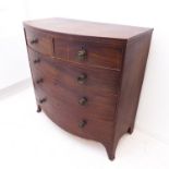 An early 19th century bow-fronted mahogany chest: two half-width over three full-width graduated