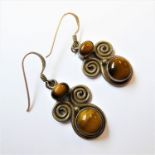 A pair of silver swirl-style earrings set with tiger's eye (boxed)