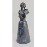 A Peruvian pottery female figure with long plaited hair and wearing a long conical-shaped skirt with