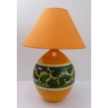 A Louis Drimmer ceramic table-lamp and shade: orange ground with a green band of foliate decoration;