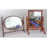 An early 20th century mahogany toilet-mirror, the oval frame with feather banding; and a modern