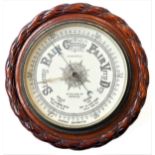 A late 19th/early 20th century aneroid barometer by A. Casartelli: the oak frame modelled as naval