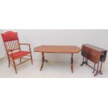 A group of three: a reproduction mahogany and satinwood crossbanded serpentine-ended coffee table on