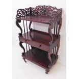 A three-tier rosewood whatnot: three-quarter pierced fretwork gallery above shelves with lyre-