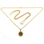 A 9-carat yellow gold, turquoise and garnet circular openwork pendant suspended from a 9-carat