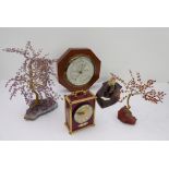 Five pieces to include a carriage-style clock, quartz ornamental 'trees' and an octagonal mahogany