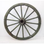 A giant antique wooden-spoked cartwheel with shaped ironwork rim. (Approx. 164 cm in diameter)