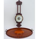 A late 19th to early 20th century barometer with carved frame (damage to glass) and an Edwardian