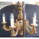 A large and heavy light-green painted and burnished gilt carved wood six-light chandelier of