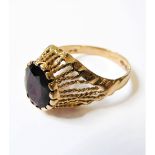 An 18-carat gold ring set with a large garnet, size P