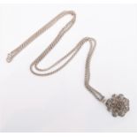 A silver filigrees pendant modelled as a flowerhead suspended from a silver chain (boxed)