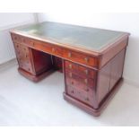 A mid-19th century mahogany partner's desk: green leather gilt-tooled inset moulded top above an