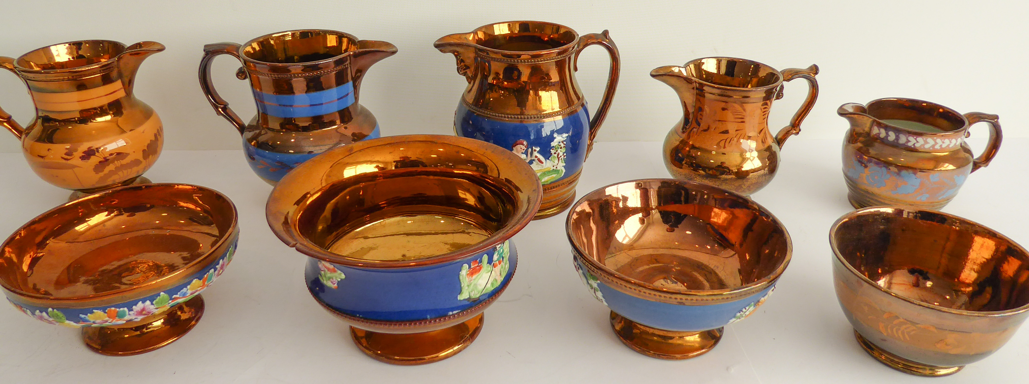 A selection of 19th century Welsh-style copper lustre comprising five jugs (the largest being 15